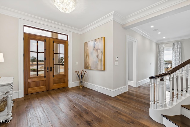 entrance foyer featuring dark wood-type flooring, ornamental molding, and french doors