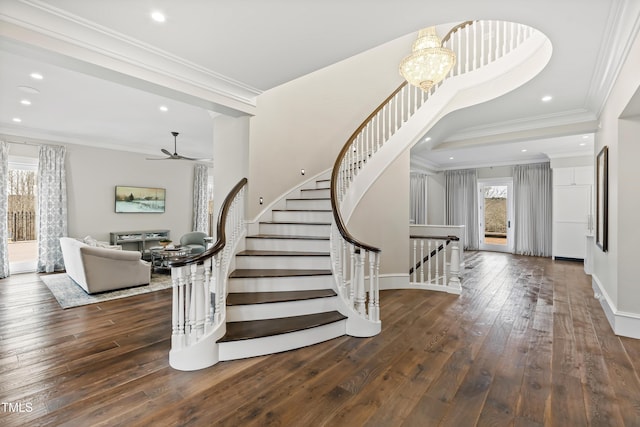 entrance foyer featuring crown molding, dark hardwood / wood-style floors, and ceiling fan with notable chandelier