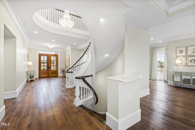 entryway featuring ornamental molding, dark wood-type flooring, a chandelier, and french doors