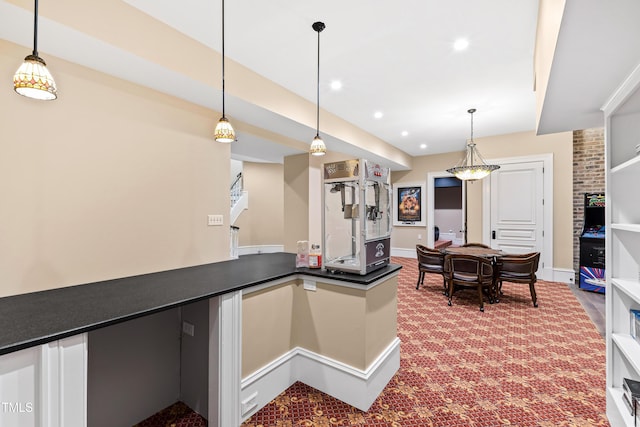 kitchen with decorative light fixtures and carpet floors