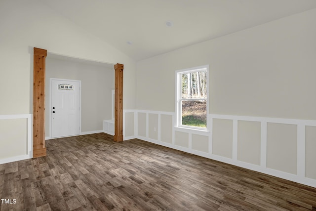 unfurnished room featuring hardwood / wood-style flooring and lofted ceiling