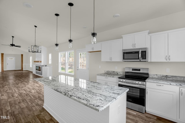 kitchen featuring white cabinets, a kitchen island, hanging light fixtures, and appliances with stainless steel finishes