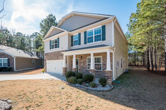 view of front facade featuring a garage, a front lawn, and a porch