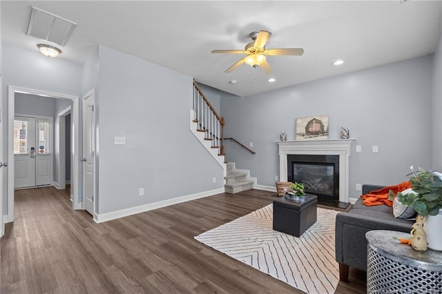 living room with hardwood / wood-style flooring and ceiling fan