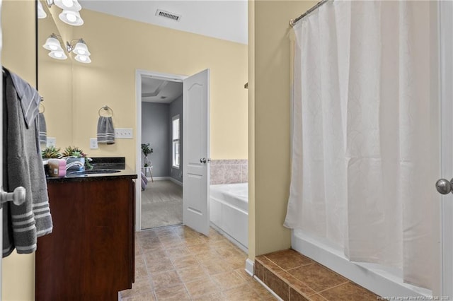 bathroom featuring sink and a washtub