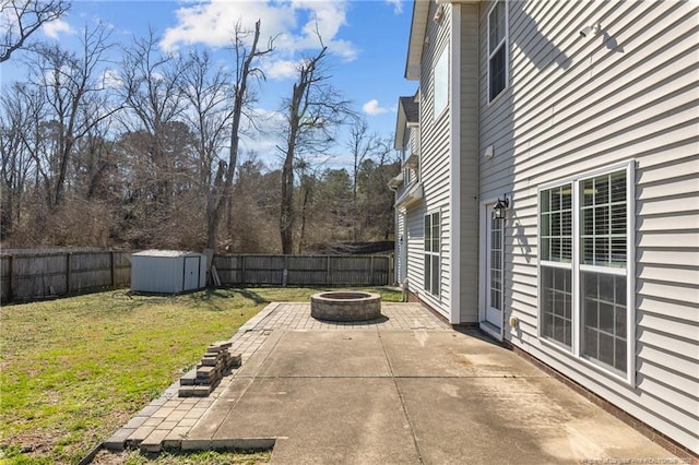 view of patio / terrace featuring a storage unit and a fire pit