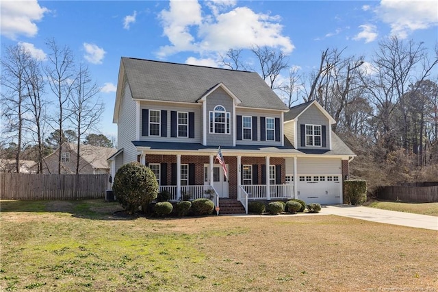 colonial inspired home with fence, driveway, a porch, a front lawn, and brick siding