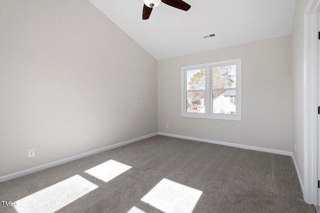 spare room with ceiling fan, lofted ceiling, and carpet