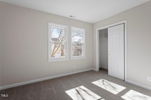 unfurnished bedroom with a closet and carpet flooring