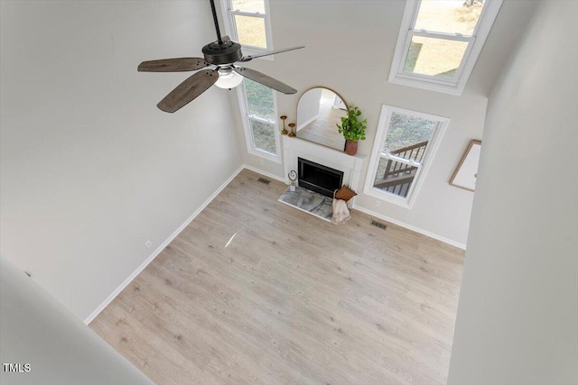 unfurnished living room featuring ceiling fan and light hardwood / wood-style flooring