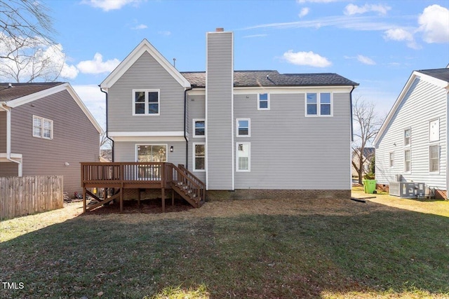 rear view of property with a yard and a deck