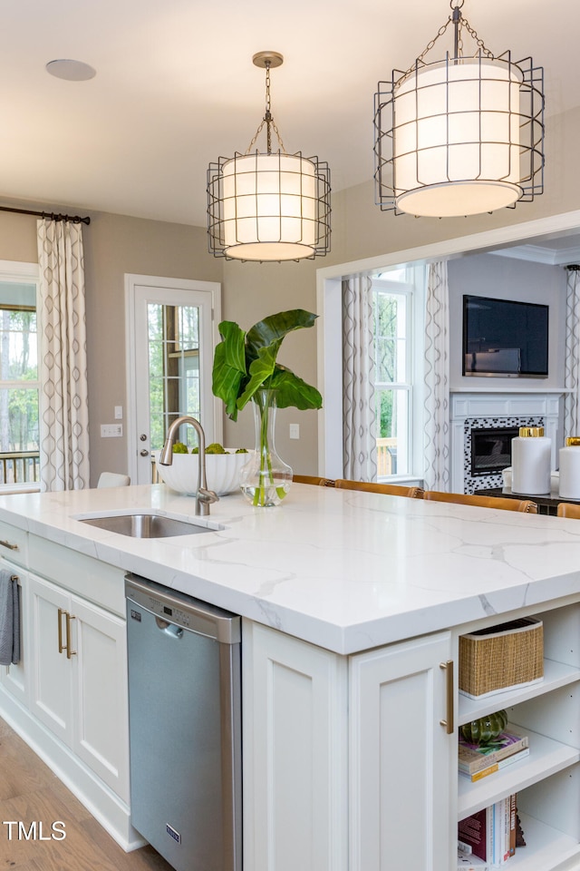 63 Rice Rd Unit 01, Zebulon, NC 27597 - kitchen with dishwasher, light stone countertops, sink, and white cabinets