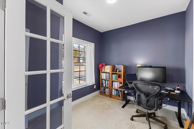 carpeted home office featuring french doors