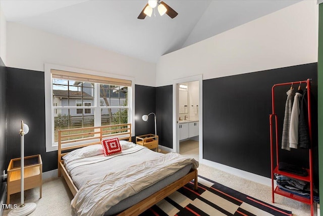 carpeted bedroom with ceiling fan, ensuite bath, and high vaulted ceiling