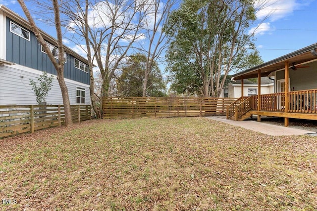 view of yard featuring a wooden deck, a patio area, and ceiling fan