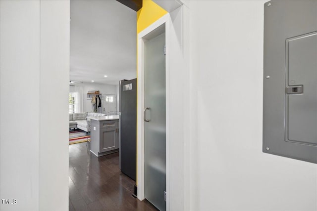 corridor with dark wood-type flooring and electric panel