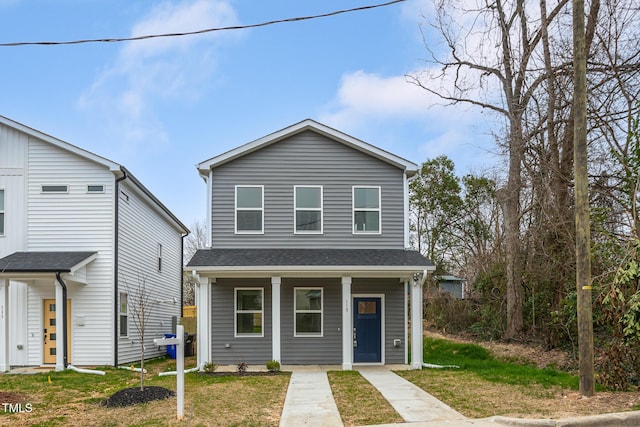 view of front of house with a porch and a front lawn