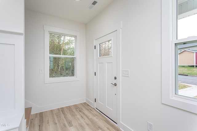 entrance foyer with light wood-style floors, visible vents, and baseboards