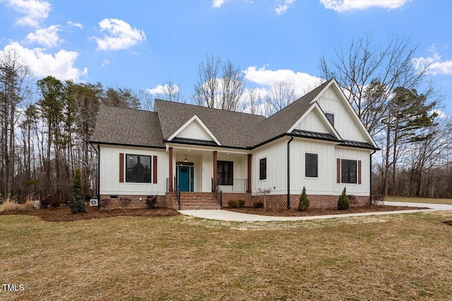 view of front facade with a front yard and covered porch