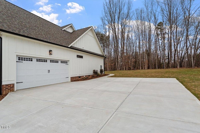 view of side of home with a garage and a yard