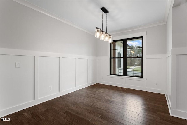 unfurnished dining area with dark hardwood / wood-style flooring, crown molding, and an inviting chandelier