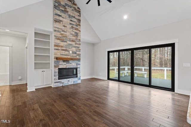 unfurnished living room with wood-type flooring, built in features, and a fireplace