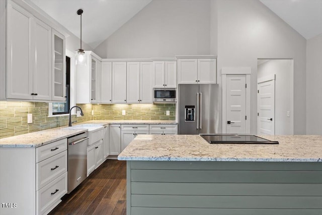 kitchen with white cabinetry, stainless steel appliances, and decorative light fixtures