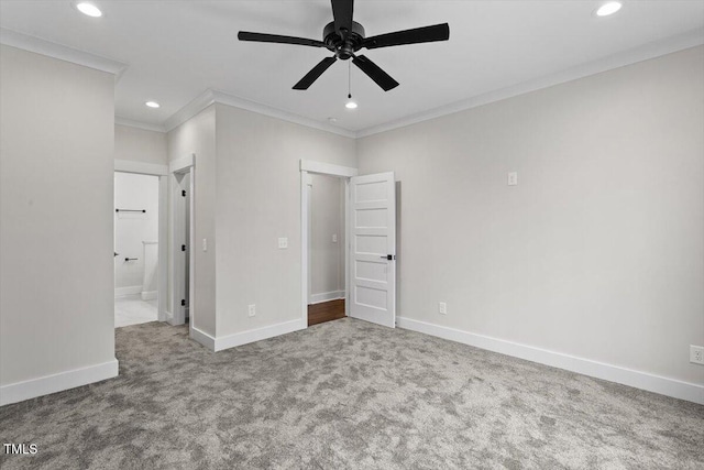 unfurnished bedroom featuring crown molding, ensuite bathroom, ceiling fan, and carpet flooring