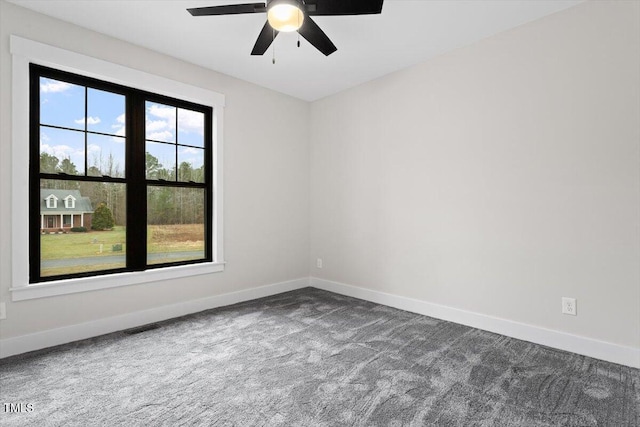 spare room with ceiling fan and carpet floors