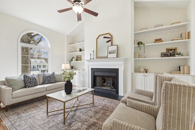 living room with high vaulted ceiling, dark hardwood / wood-style floors, ceiling fan, and built in shelves