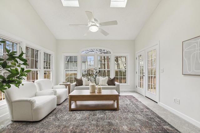 sunroom with lofted ceiling with skylight and ceiling fan