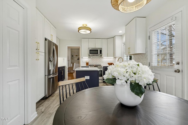 dining space with light wood-type flooring