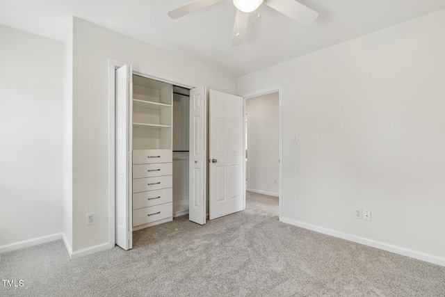 unfurnished bedroom featuring ceiling fan, light colored carpet, and a closet