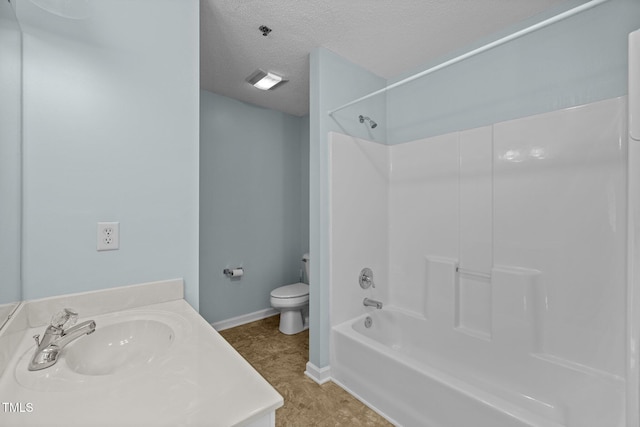 full bathroom with a textured ceiling, toilet, shower / washtub combination, and vanity