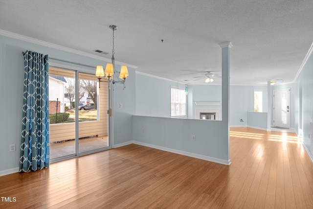 unfurnished room with a textured ceiling, light hardwood / wood-style flooring, and ornamental molding