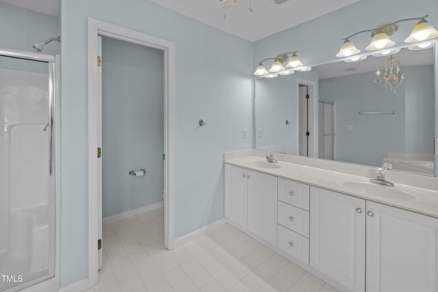 bathroom featuring a shower with door and vanity