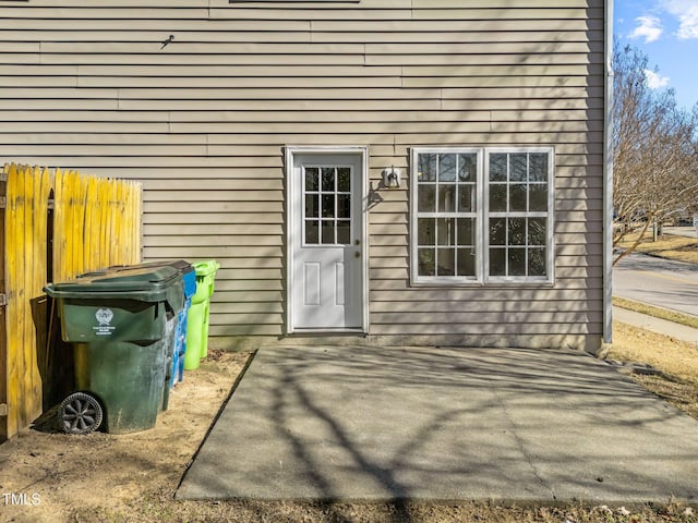 doorway to property with a patio and fence