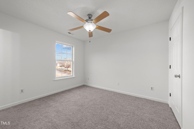 unfurnished bedroom with carpet flooring, ceiling fan, visible vents, and baseboards