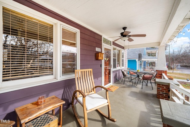 view of patio with a water view and ceiling fan