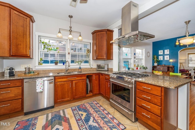 kitchen with pendant lighting, appliances with stainless steel finishes, island range hood, and sink