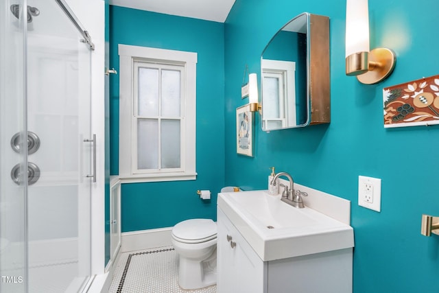 bathroom featuring vanity, tile patterned flooring, a shower, and toilet