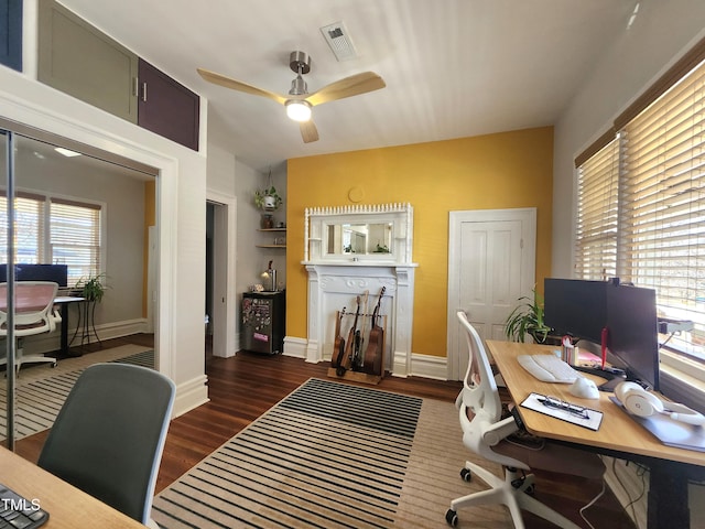 office area featuring dark wood-type flooring and ceiling fan