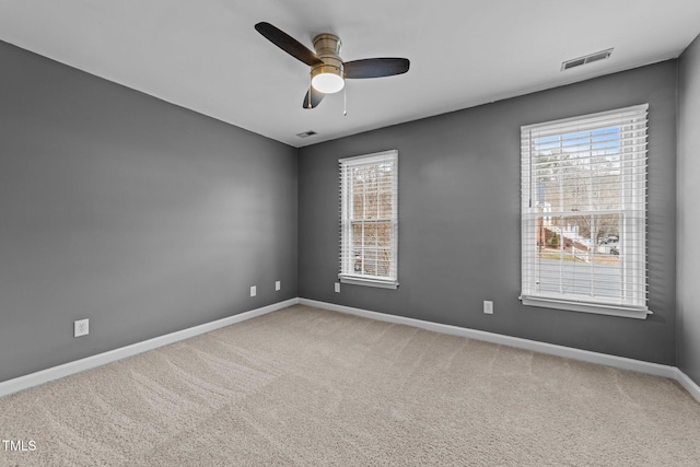 spare room with carpet, plenty of natural light, and ceiling fan