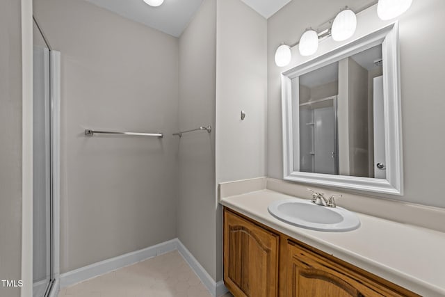 bathroom featuring vanity, a shower with shower door, and tile patterned flooring