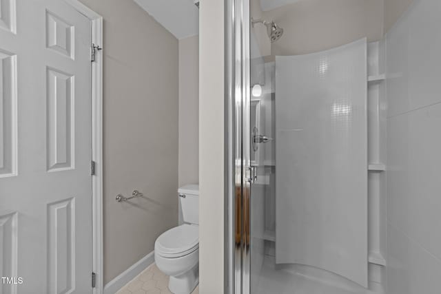 bathroom featuring toilet and walk in shower