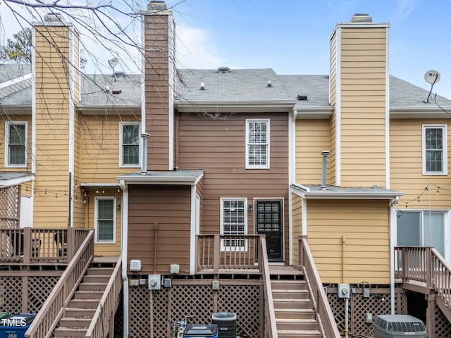 rear view of house with cooling unit and a deck