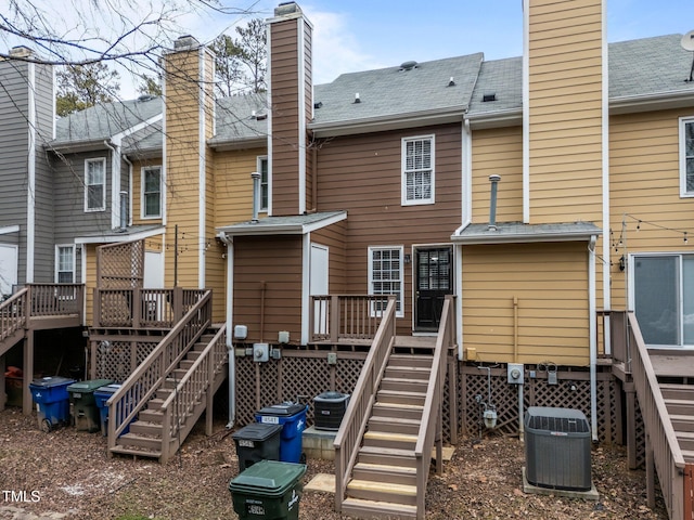 back of house featuring a wooden deck and central AC