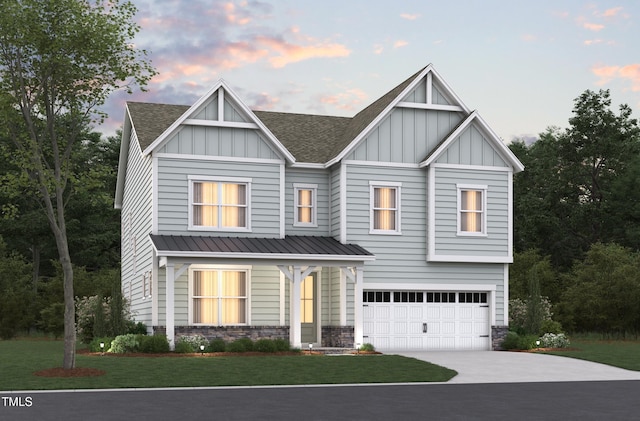 view of front of house featuring a garage and a lawn