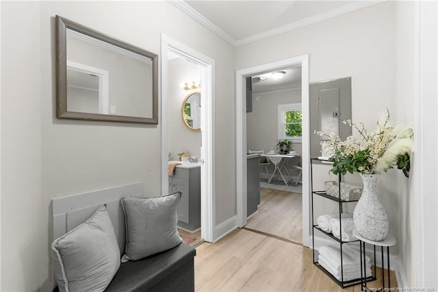 sitting room featuring electric panel, crown molding, and light hardwood / wood-style floors