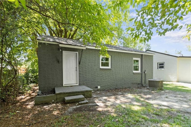 back of house featuring central AC